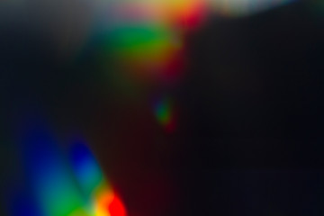 Lens flare and light leak haze texture on a black background.