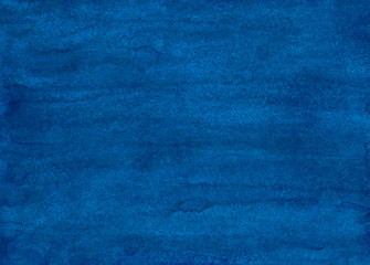 Watercolor deep blue background painting. Hand painted watercolour backdrop. Stains on paper texture.