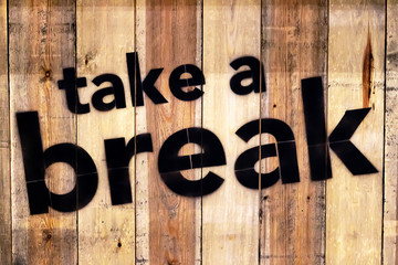 Take a break sign on wood.