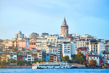 Fototapeta premium Istanbul cityscape in Turkey with Galata Kulesi Tower. Ancient Turkish famous landmark in Beyoglu district, European side of city. Architecture of the Constantinople.Historical place made by Genoese