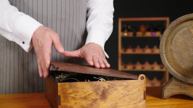 Man taking bottle of expensive wine from box in cellar
