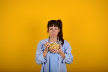 cheerful woman eating popcorn watching a comedy movie
