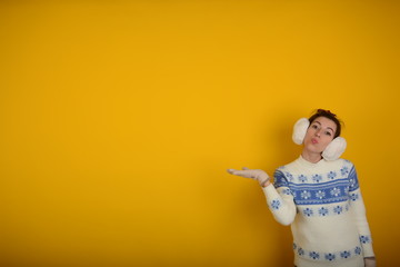 a woman in a sweater with emotions on the face on a hand free place