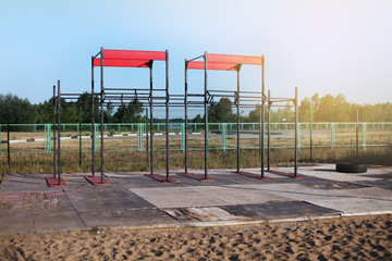 Workout training gym outdoor. Sport and fitness concept. Summer at the city beach.