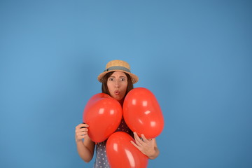 woman in hat with red balloons