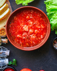 red tomato soup and vegetables and meat, borsch cuisine menu concept keto or paleo diet background. top view. copy space for text