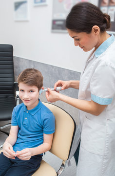 Process Of Making A Custom Earplug For A Child. Stages Of Manufacturing Earplugs. Audiologist Makes Custom Molded Ear Plugs For The Patient