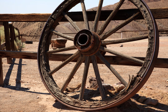 Calico, California / USA - August 23, 2015: An old wooden wheel in Calico Ghost Town, Calico, California, USA