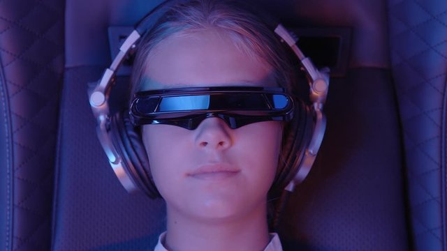 Girl puts on augmented reality futuristic AR headset.
