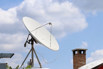 Satellite dish with head on roof