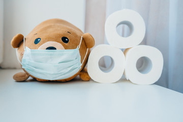 Disposable medical protective face mask on brown teddy bear