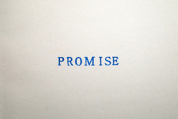 a PROMISE word stamped on a piece of paper.