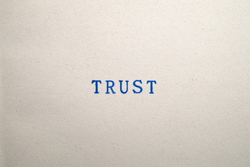 a TRUST word stamped on a piece of paper.