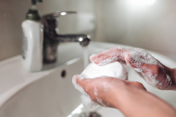 Fototapeta premium Man washing hands to protect against the coronavirus