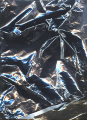 Holographic foil paper close-up with rainbow lights. Modern trendy background. Contrasty crumpled foil package bag. Clean packing aluminium, holographic image, silver plastic bag, iridescent color