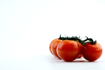 small cherry tomatoes on a white background