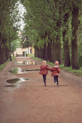 children run along the alley of trees