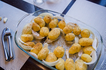 potatoes with onions and garlic in a dish