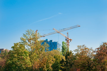 Construction site of modern building with glass facade in the park