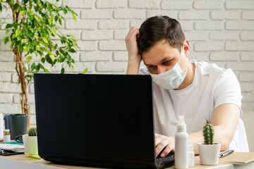 Sick man with medical protective mask on his face working in office. Coronavirus outbreak concept