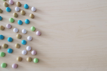 Colored wooden Easter eggs on table.