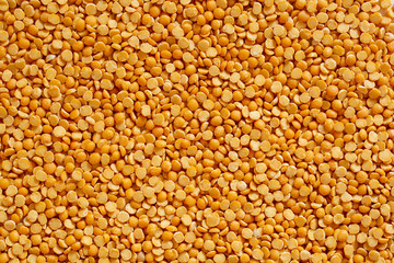 Yellow split peas background. Dry cereal for cooking.