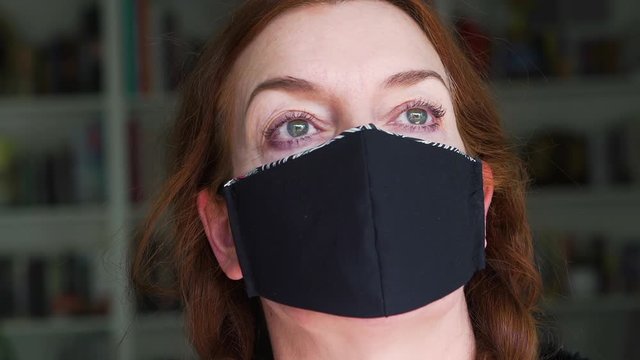 Portrait of an an experienced fashion designer wearing the face mask that she created at home from recycled fabric as a protection against viruses, disease and germs