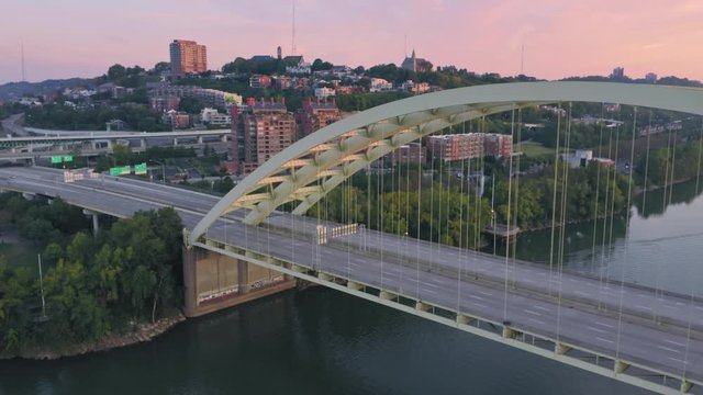 Aerial: Freeway traffic crossing the Daniel Carter Beard Bridge over the Ohio River. Cincinnati, Ohio