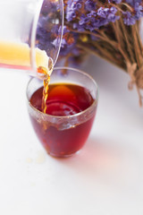 White background, strong, morning, specialty coffee brewed by an alternative method from gadget. Bouquet of field flowers and glassware.