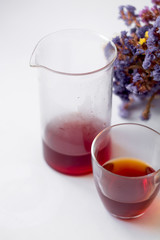 White background, strong, morning, specialty coffee brewed by an alternative method from gadget. Bouquet of field flowers and glassware.