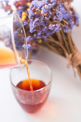 White background, strong, morning, specialty coffee brewed by an alternative method from gadget. Bouquet of field flowers and glassware.