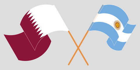 Crossed and waving flags of Argentina and Qatar