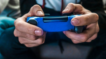 Man hold the gamepad in hands, playing game. One gamer person, close-up