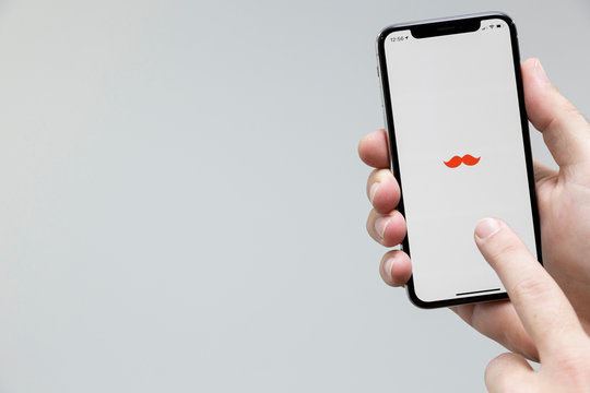 Sao Paulo, Brazil; March 25, 2020: Man holding a Smartphone with Rappi logo on it. Rappi is a Brazilian company in the segment of delivery, Brasilian Fintech.