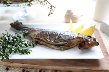 Trout. Baked fish, served with a green salad.
Exquisite, tasty dinner dish. Serving suggestions, culinary photography.
