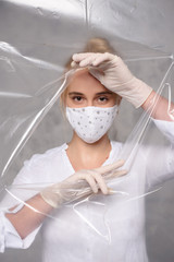 Quarantined woman wears a protective mask.
Quarantined woman breakthrough of oilcloth.