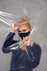 Quarantined woman wears a protective mask.
Quarantined woman breakthrough of oilcloth.