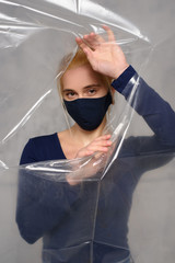 Quarantined woman wears a protective mask.
Quarantined woman breakthrough of oilcloth.