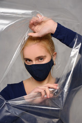 Quarantined woman wears a protective mask.
Quarantined woman breakthrough of oilcloth.