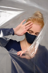 Quarantined woman wears a protective mask.
Quarantined woman breakthrough of oilcloth.