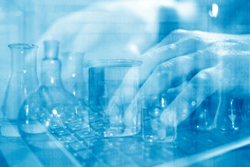 Close up of scientist's hands working on laptop computer searching for cure or vaccine. Laboratory transparent glassware instruments. Empty equipment for chemical lab in realistic style.