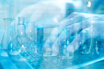 Close up of scientist's hands working on laptop computer searching for cure or vaccine. Laboratory transparent glassware instruments. Empty equipment for chemical lab in realistic style.