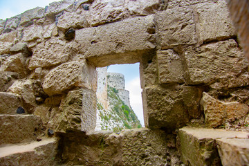 Krak (Crac) des Chevaliers, also called (‎Castle of the Kurds), and formerly Crac de l'Ospital, is a Crusader castle in Syria and one of the most important preserved medieval castles in the world. - obrazy, fototapety, plakaty