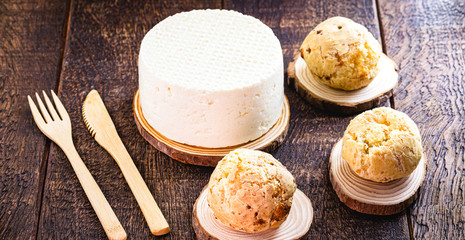 homemade Brazilian cheese bread basket, rustic wood background.