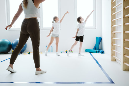 Teenage kids exercising during sport class at school gym