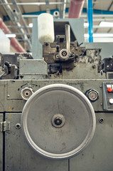 A toilet paper making machine, producing toilet and bathroom paper rolls due to Corona virus panic buying.  Paper and tissue manufacturers factory and engineered machinery.