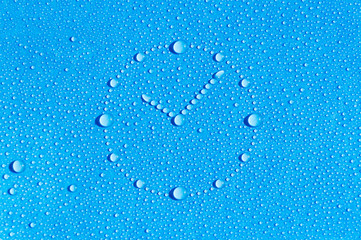Drops of water in the form of a dial are located on a wet blue background. Dial made of water...