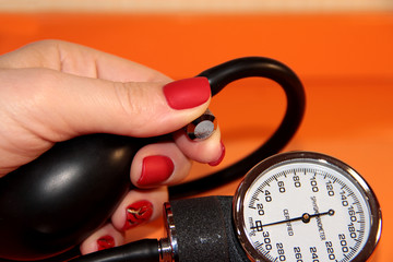 Tonometer in a woman's hand with a manicure. A device for measuring pressure.