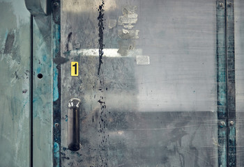 plastic sliding blast shield doors in a manufacturing factory. Plastic doors to contain spray paint and sand blasting industry. Futuristic science fiction style space station protective door hatch.