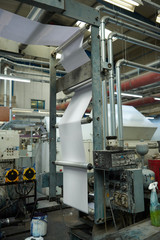 london, england, 29/03/2020 A toilet paper making machine, producing toilet and bathroom paper rolls due to Corona virus panic buying.  Paper and tissue manufacturers factory and engineered machinery.